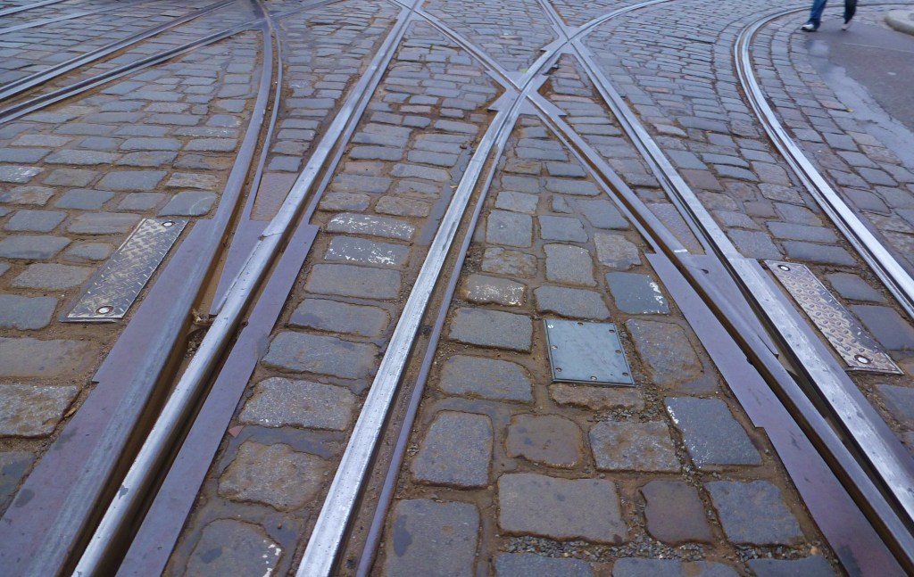 Wet metal and stones.  Trams and cars and pedestrians... ahhhhhhh!